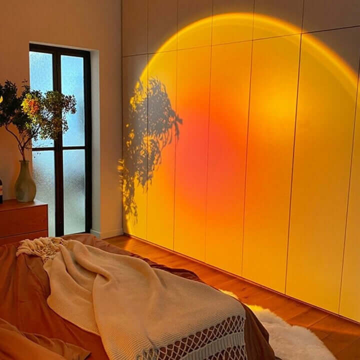 Sunset lamp casting a large orange and red gradient on the wall in a modern living room, creating a warm and cozy evening atmosphere.